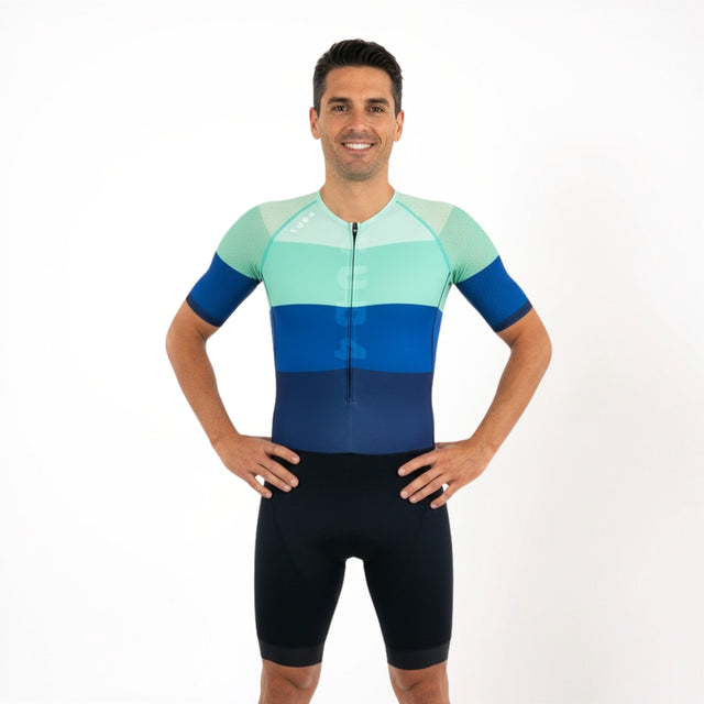 Man wearing a colourful Triathlon suit on a white background