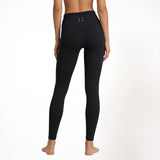 Black athletic gym yoga leggings worn by a person on a white background