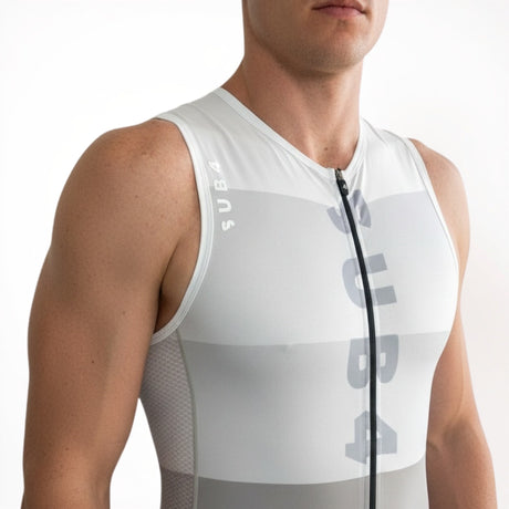 Person wearing a white sleeveless athletic outfit with branding on a white background